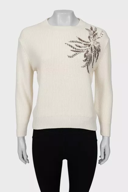 Knitted sweater decorated with sequins