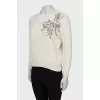 Knitted sweater decorated with sequins