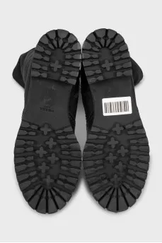 Black boots made of leather and textile