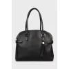 Leather bag decorated with buckles