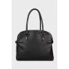 Leather bag decorated with buckles