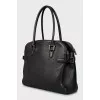 Leather bag decorated with buckles
