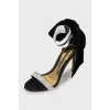 Black sandals decorated with a bow