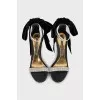 Black sandals decorated with a bow