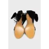Black sandals decorated with a bow