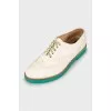 Leather brogues with green sole
