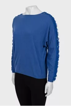 Blue jumper decorated with weaving