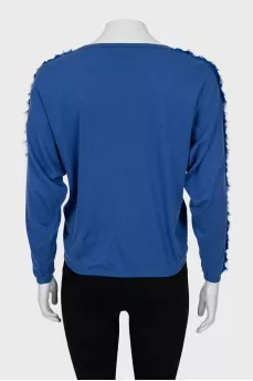 Blue jumper decorated with weaving