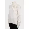 Knitted golf shirt decorated with a flower