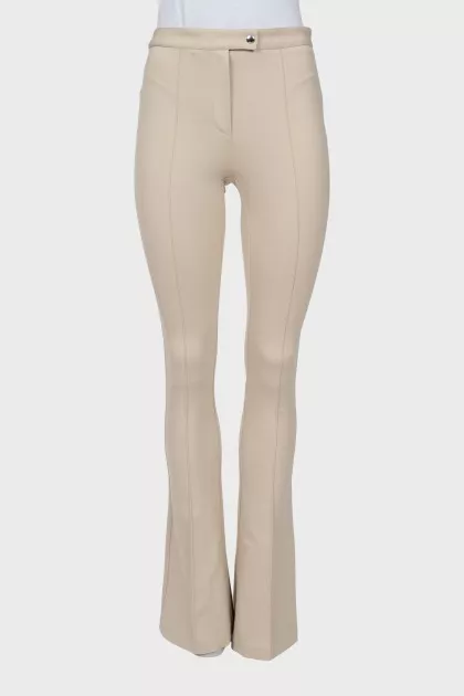 Beige flared trousers with stitched creases