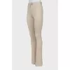 Beige flared trousers with stitched creases