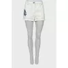 White denim shorts with patches
