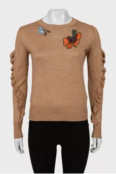 Sweater with embroidery and ruffles