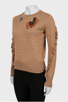 Sweater with embroidery and ruffles