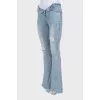 Blue flared jeans with a distressed effect