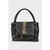 Leather bag decorated with chains