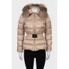 Beige down jacket with fur on the hood