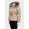 Beige down jacket with fur on the hood