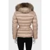 Beige down jacket with fur on the hood