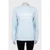 Light blue sweatshirt with text print