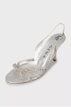 Silver sandals decorated with rhinestones