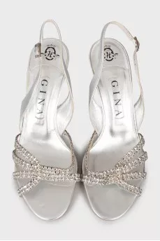 Silver sandals decorated with rhinestones