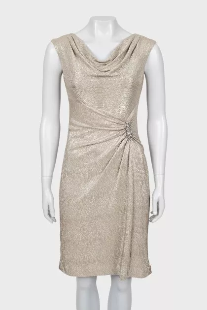 Golden dress decorated with a brooch
