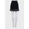Black mini skirt with ruffled hem
