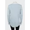 Blue pullover extended at the back