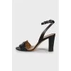 Black leather sandals with metallic decor