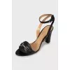 Black leather sandals with metallic decor