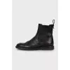Black leather boots with perforations
