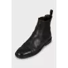 Black leather boots with perforations