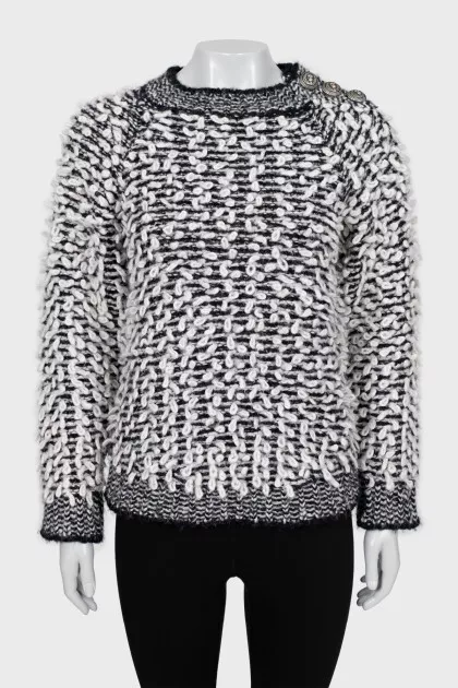 Knitted sweater decorated with buttons