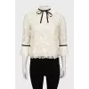 Blouse decorated with frills and ribbon
