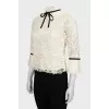 Blouse decorated with frills and ribbon
