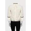 Blouse decorated with frills and ribbon