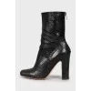 Black snakeskin ankle boots