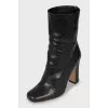 Black snakeskin ankle boots