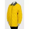 Reversible quilted jacket with tag