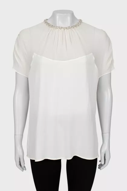White blouse decorated with rhinestones