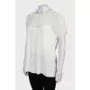 White blouse decorated with rhinestones