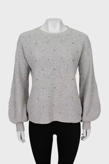 Knitted gray sweater decorated with rhinestones