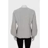 Knitted gray sweater decorated with rhinestones