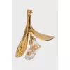 Golden brooch with stones