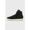 Suede sneakers decorated with fringes