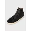Suede sneakers decorated with fringes