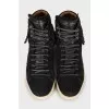 Suede sneakers decorated with fringes