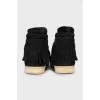Suede sneakers decorated with fringes
