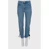 Blue jeans decorated with ties